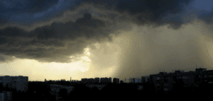 Dark storm clouds and heavy rain over residential buildings