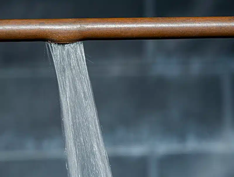Water gushing from a burst pipe inside a home.