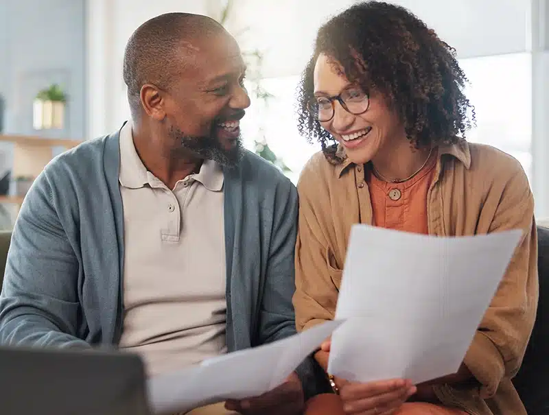 Homeowners smiling after resolving a frozen pipe claim with the help of Robinhood Adjusters.