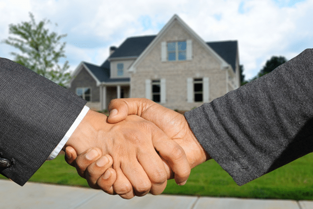 Connecticut homeowner shaking hands with insurance representative after claim resolution.