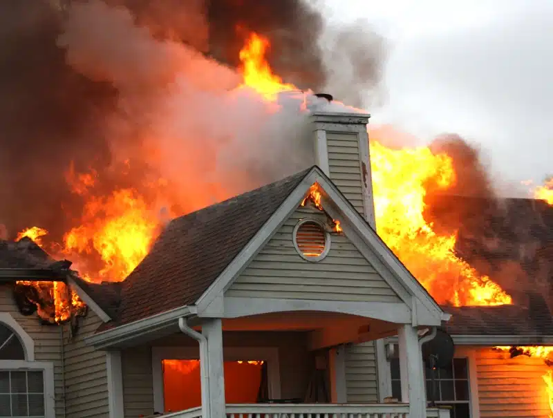 House engulfed in flames during a residential fire.