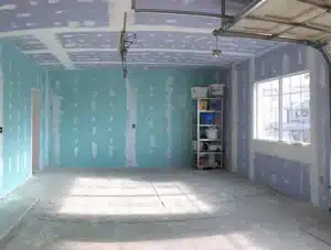 Garage walls finished with mold-resistant drywall during renovation.