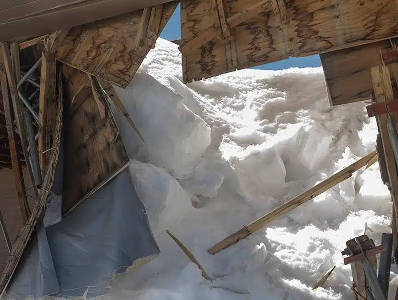 Collapsed roof from heavy snow and ice buildup on a Connecticut home