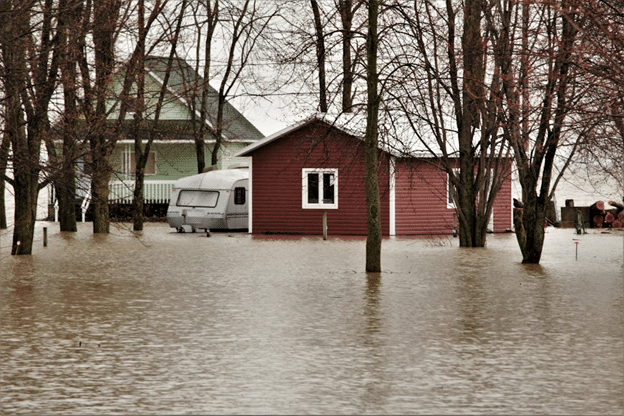 Residential homes surrounded by severe floodwater during a major water damage event.